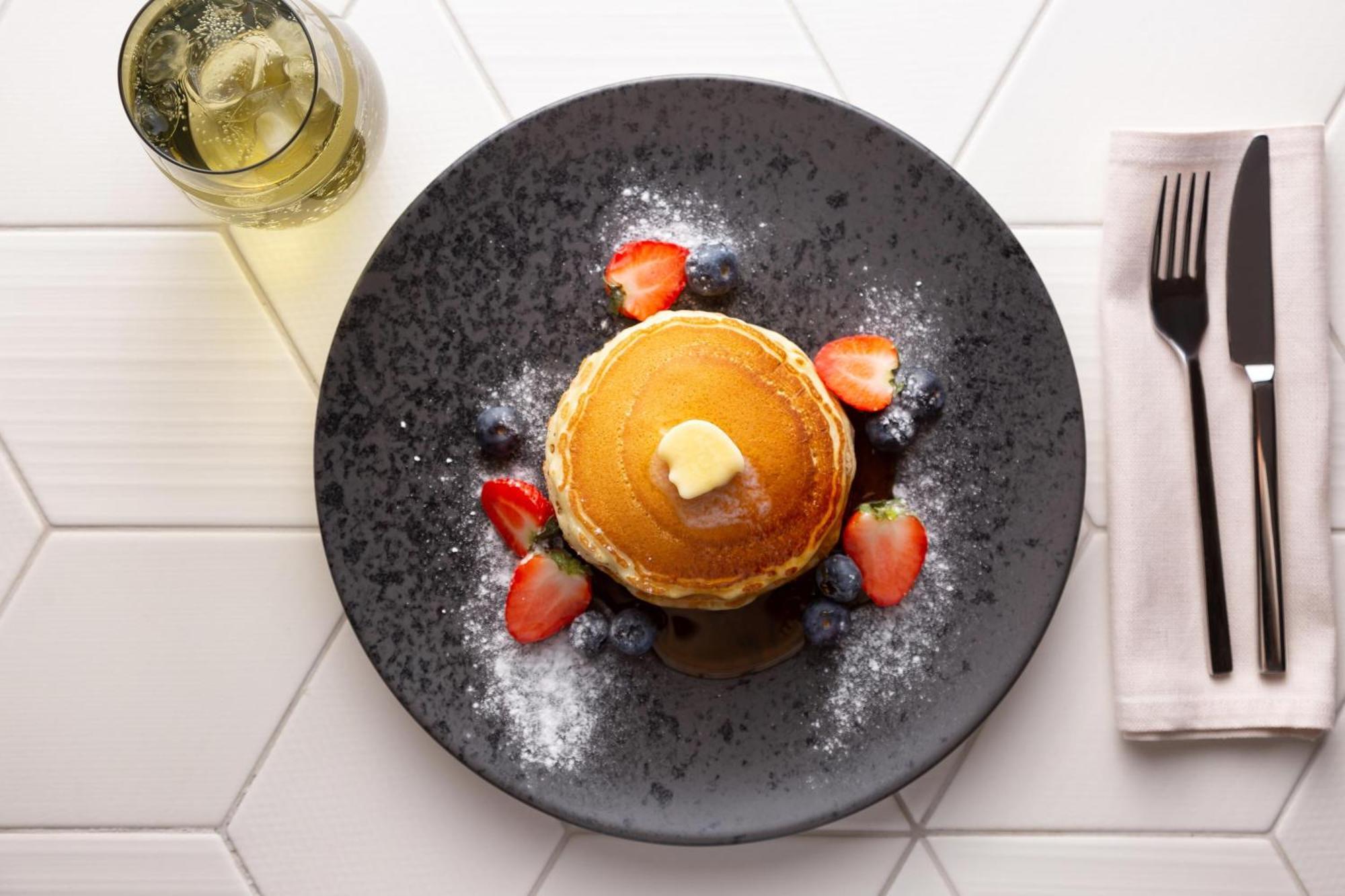 Sheraton Astana Hotel Bagian luar foto A stack of pancakes with fruit